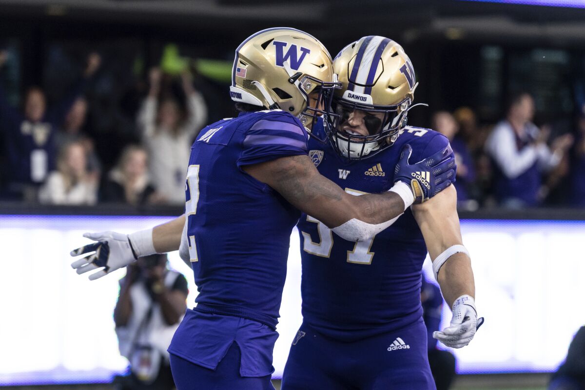 Washington tight end Jack Westover and wide receiever Ja'Lynn Polk celebrate a touchdown against Michigan State.