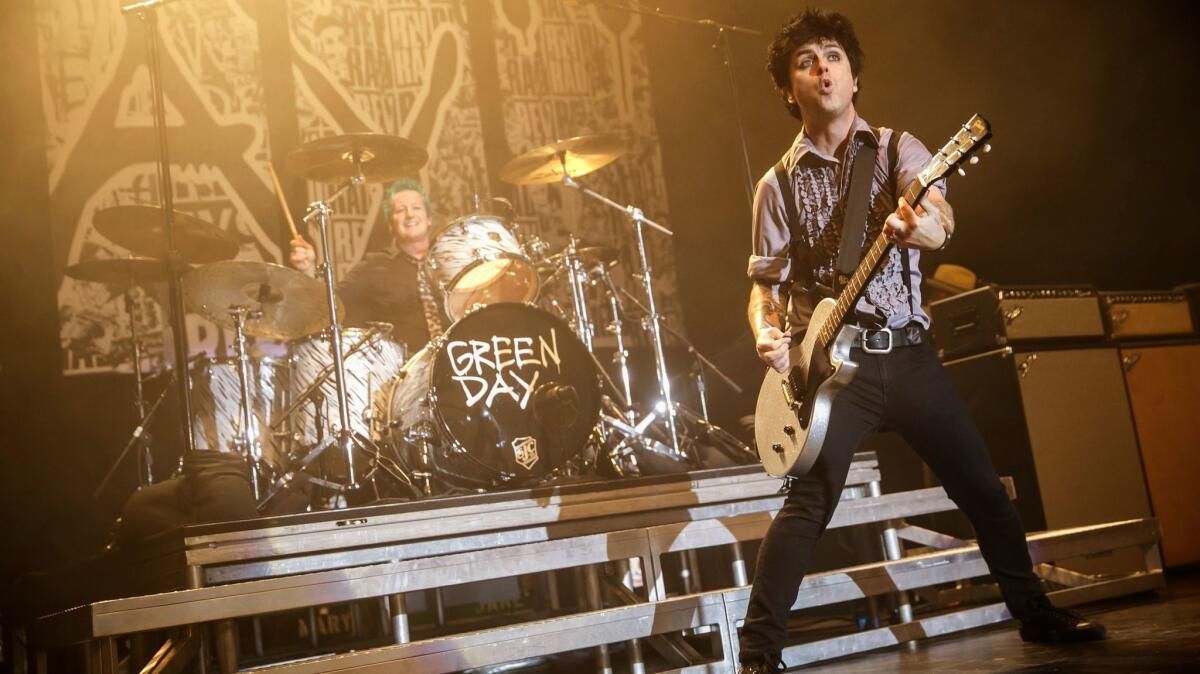 Green Day, shown at the Palladium last month, will headline KROQ's annual Almost Acoustic Christmas concert next month.