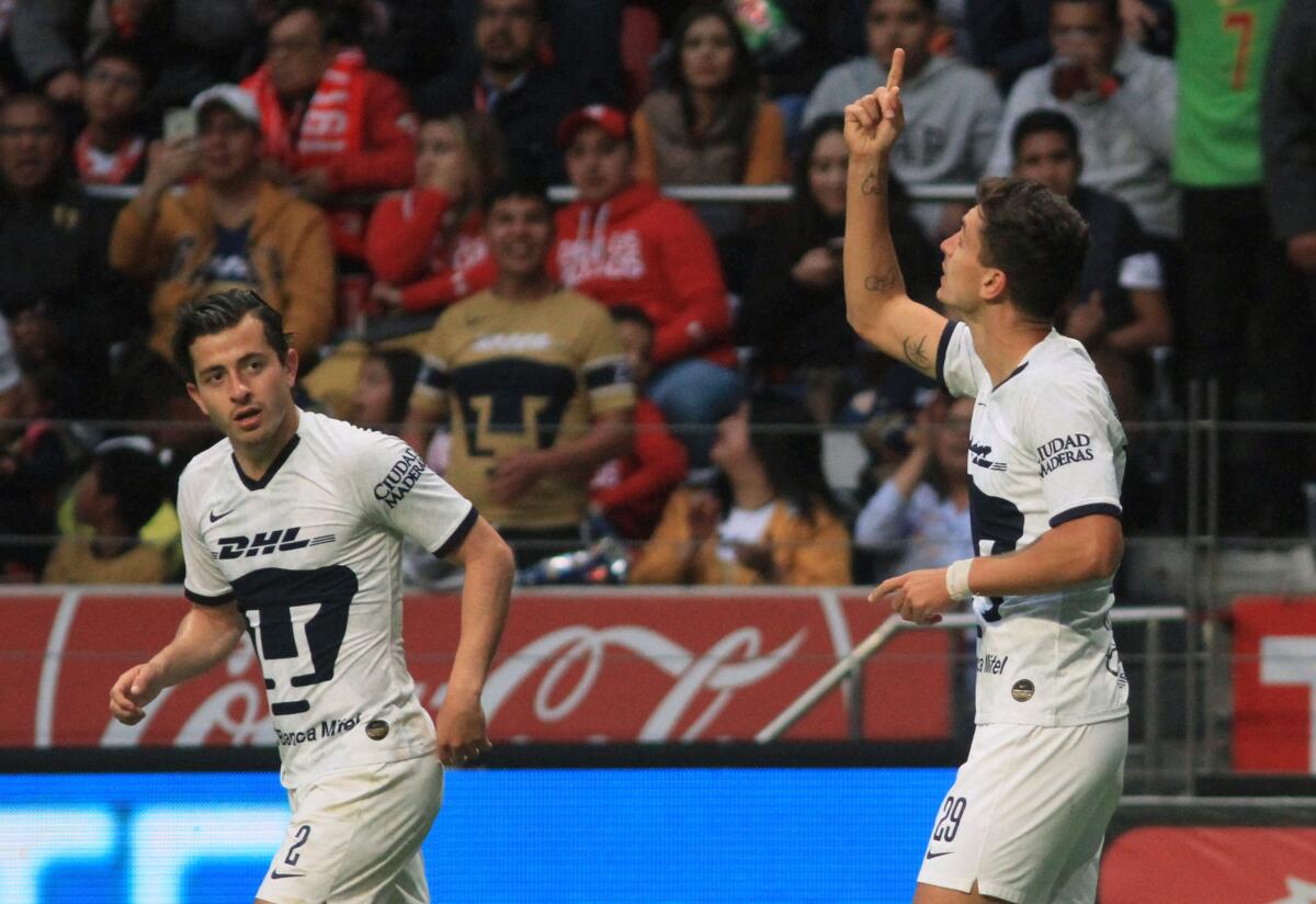 Juan Dinenno (R) of Pumas celebrates with a teammate his goal against Toluca during the Mexican Clausura 2020 tournament football match at Nemesio Diez stadium in Toluca, Mexico state, Mexico on February 15, 2020. (Photo by ROCIO VAZQUEZ / AFP) (Photo by ROCIO VAZQUEZ/AFP via Getty Images) ** OUTS - ELSENT, FPG, CM - OUTS * NM, PH, VA if sourced by CT, LA or MoD **
