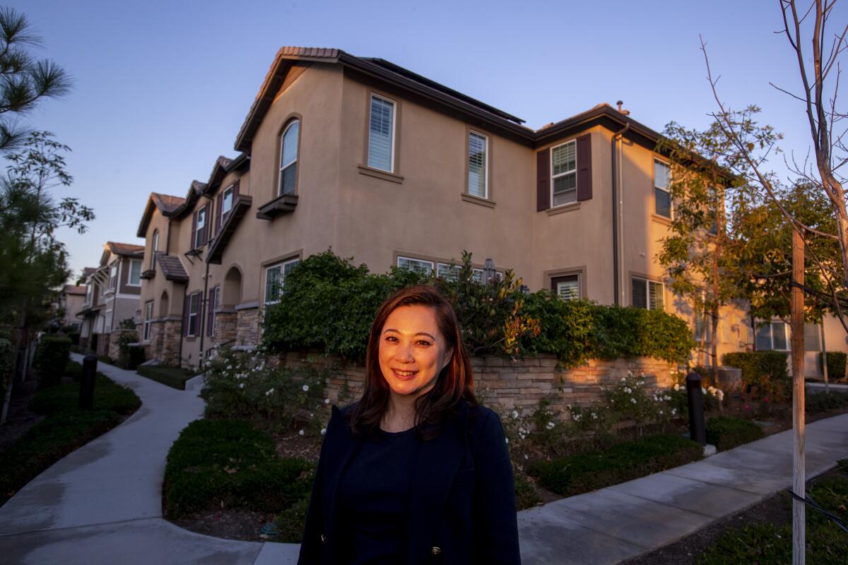 Yorba Linda City Councilwoman Peggy Huang stands in front of three- and four-bedroom townhomes in  the city.