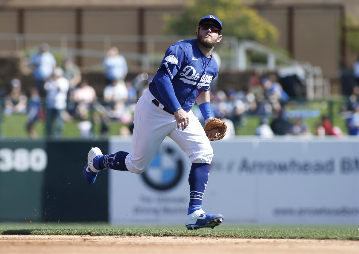 Dodgers' Max Muncy chases down a fly ball while playing second base during a Cactus League game against the Chicago White Sox on Feb. 24 at Camelback Ranch.