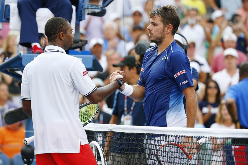 Donald Young, left, and Stan Wawrinka meet at the net after their 2015 US Open match.