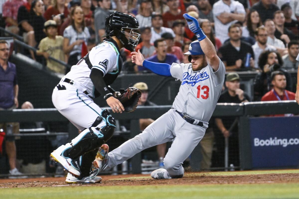 Max Muncy scores for the Dodgers during the seventh inning in Game 3 of the NLDS on Wednesday night.