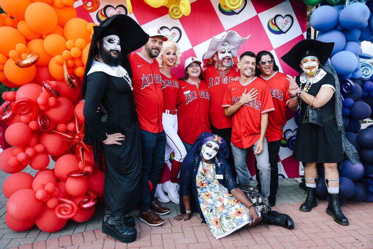 The Sisters of Perpetual Indulgence interact with fans during Pride night at Angel Stadium.