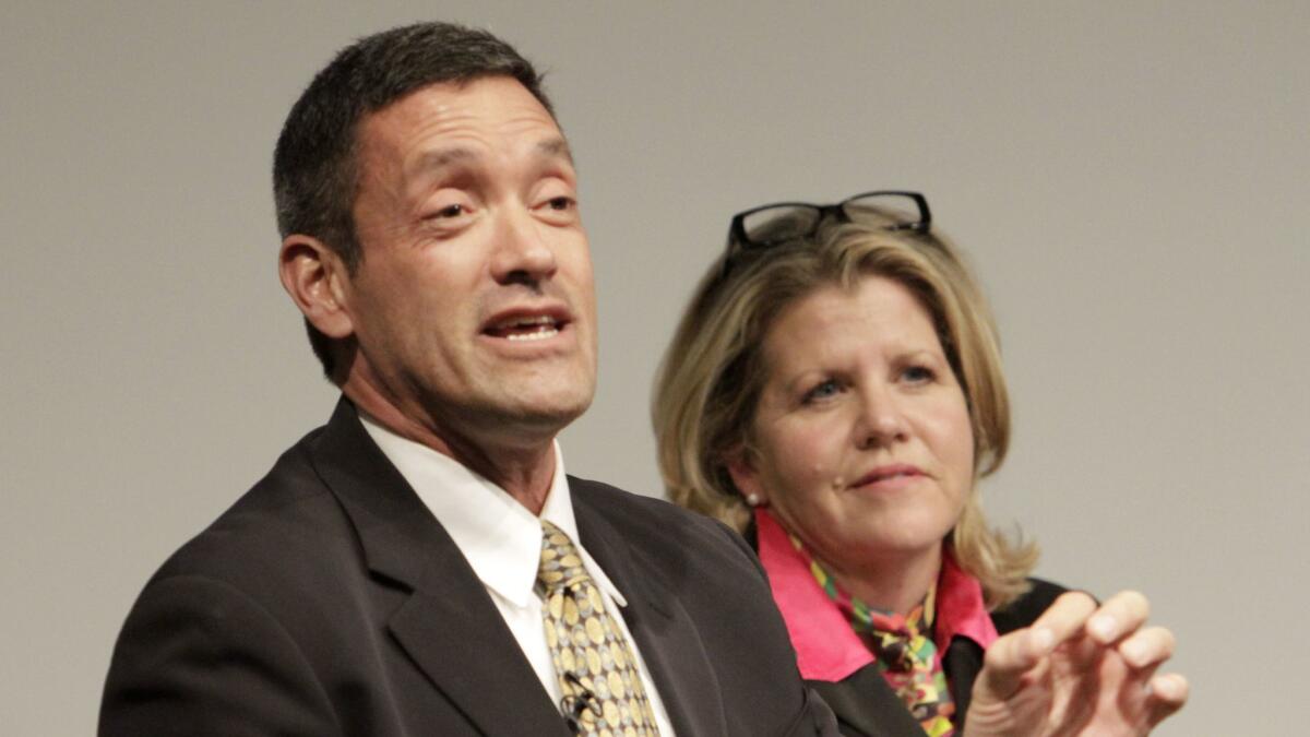 West Hollywood Mayor John Duran, pictured with Pamela Conley Ulich in 2014, has refused calls to step down.