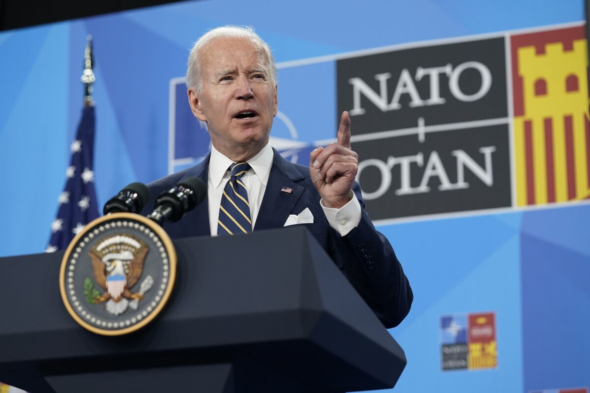 President Biden stands at a lectern, gesturing with his hand as he speaks.