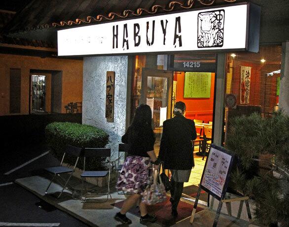 Diners at the entrance of Habuya in Tustin.