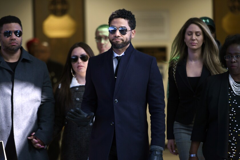 FILE - In this March 26, 2019 file photo, actor Jussie Smollett gestures as he leaves Cook County Court after his charges were dropped in Chicago. Smollett faces new charges for reporting an attack that Chicago authorities contend was staged to garner publicity, according to media reports Tuesday, Feb. 11, 2020. The charges include disorderly conduct counts, according to the reports that cite unidentified sources. (AP Photo/Paul Beaty, File)