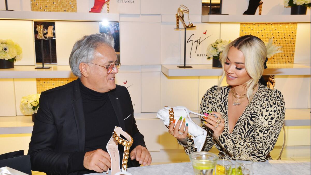 Shoe designer Giuseppe Zanotti, left, and Rita Ora at Saks Fifth Avenue in Beverly Hills.