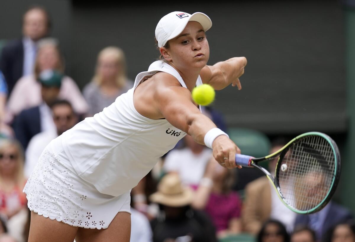 Australia's Ashleigh Barty plays a return to Germany's Angelique Kerber during the women's singles semifinals match on day ten of the Wimbledon Tennis Championships in London, Thursday, July 8, 2021. (AP Photo/Kirsty Wigglesworth)
