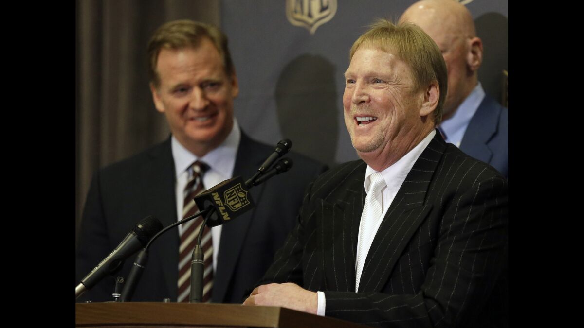 NFL Commissioner Roger Goodell, left, laughs as Oakland Raiders owner Mark Davis talks to reporters after the NFL owners meeting in Houston on Jan. 12.