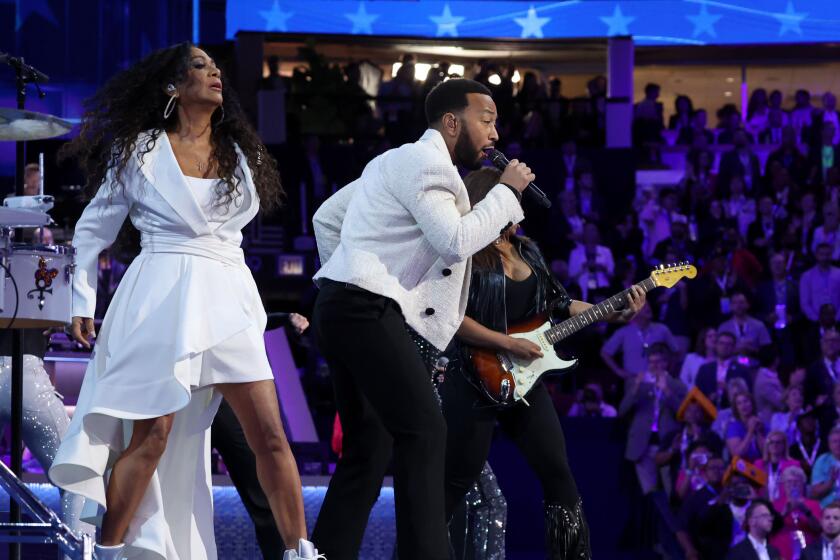 DNC CHICAGO, IL AUGUST 21, 2024 - Sheila E., left, and John Legend perform during the Democratic National Convention Wednesday, Aug. 21, 2024, in Chicago. (Robert Gauthier/Los Angeles Times)