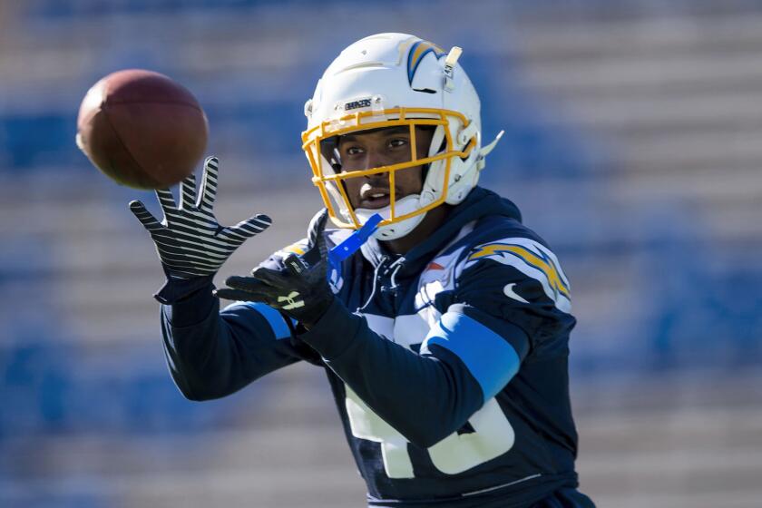 Chargers cornerback Michael Davis catches a pass during a team practice session.