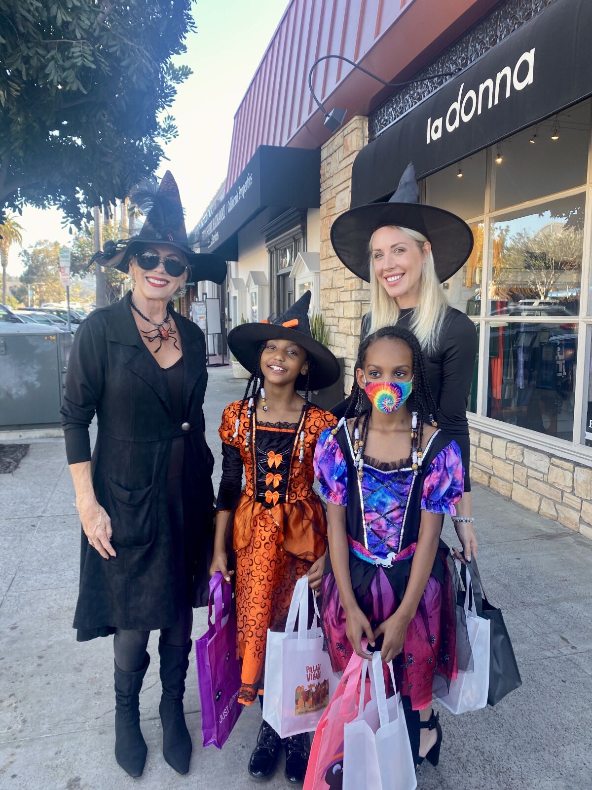 Trick-or-treaters get prize bags from the La Jolla Real Estate Brokers Association during the 2021 "Pillage the Village."