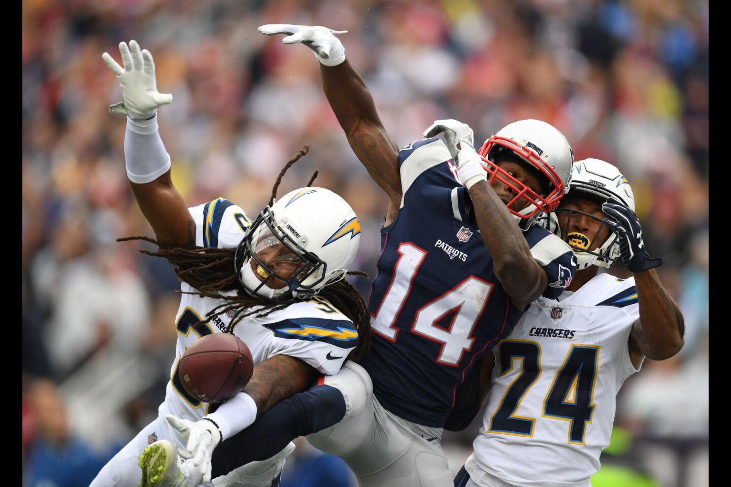 Chargers free safety Tre Boston, left, and cornerback Trevor Williams, right, break up a reception attempt by New England Patriots wide receiver Brandin Cooks during the first half.