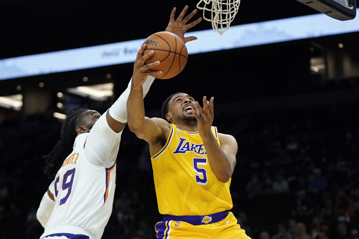 Lakers guard Talen Horton-Tucker (5) is fouled by Suns forward Jae Crowder.