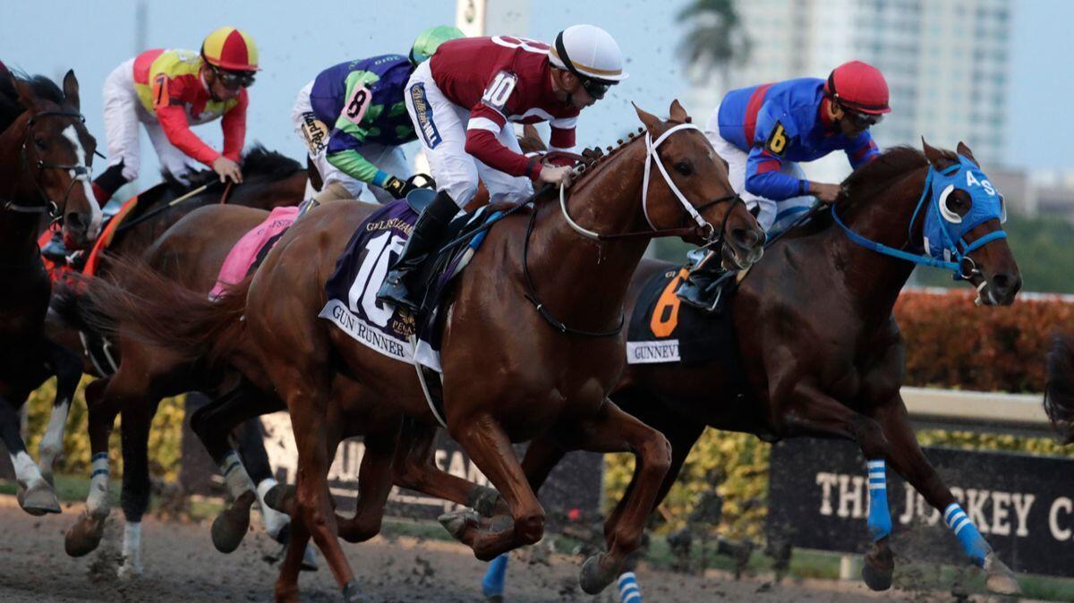 Jockey Florent Geroux (10) rides Gun Runner to victory in the Pegasus World Cup Invitational on Saturday at Gulfstream Park in Hallandale Beach, Fla.