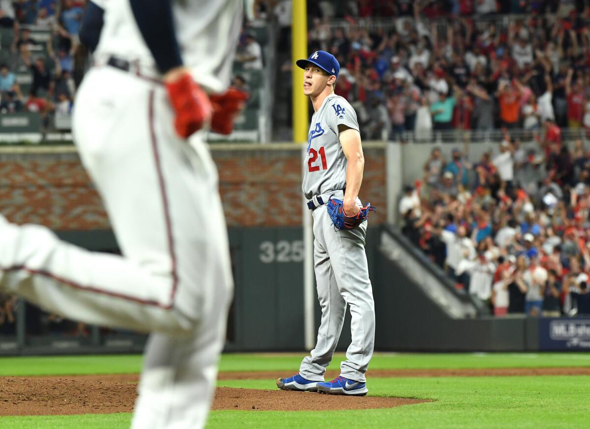 Dodgers pitcher Walker Buehler can only watch as Ronald Acuna Jr. hits a grand slam in the second inning on Sunday.