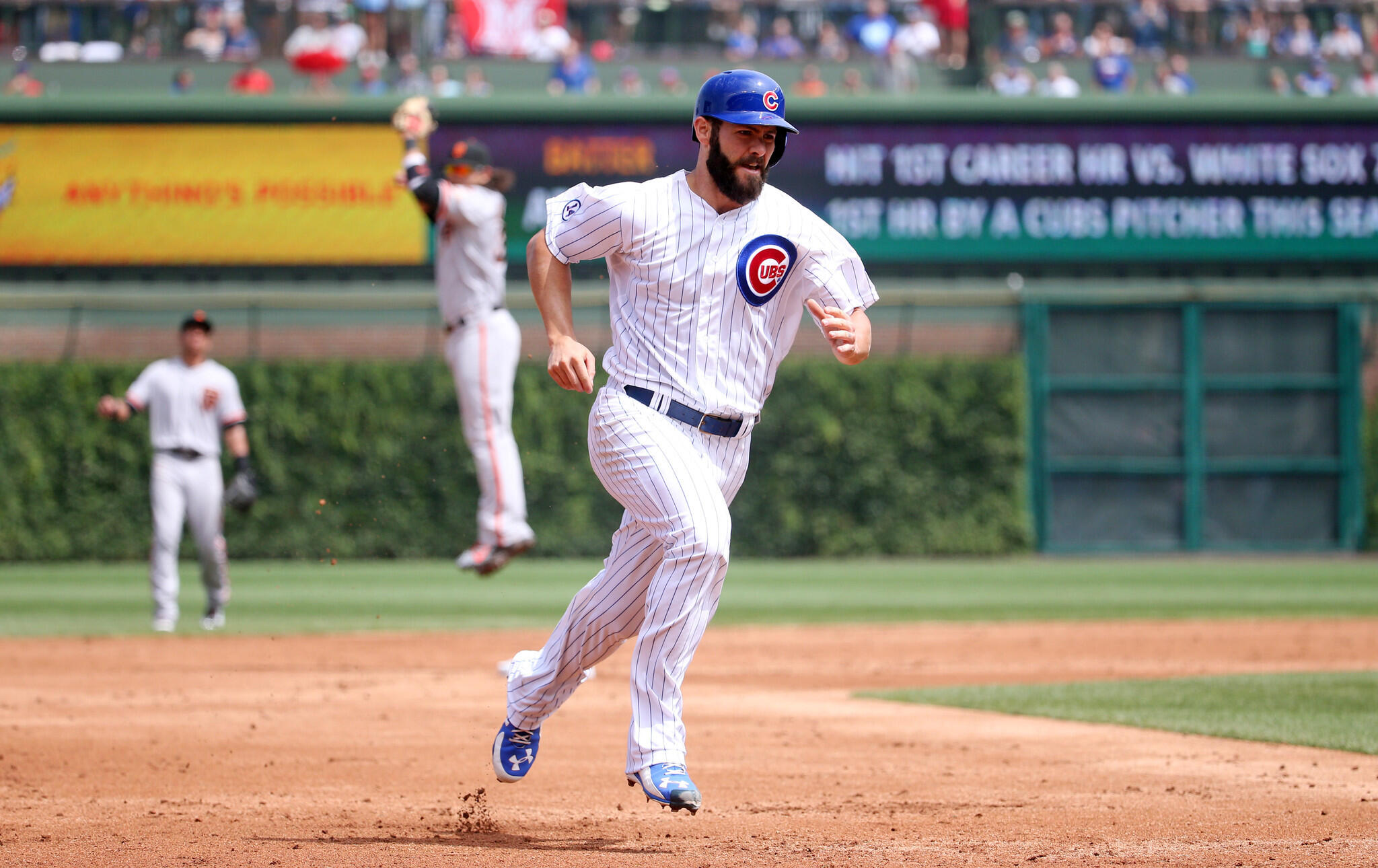 Jake Arrieta triples against the Giants in the second inning.