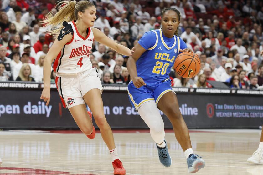 UCLA's Charisma Osborne, right, tries to dribble past Ohio State's Jacy Sheldon, left, during the first half of an NCAA college basketball game Monday, Dec. 18, 2023, in Columbus, Ohio. (AP Photo/Jay LaPrete)