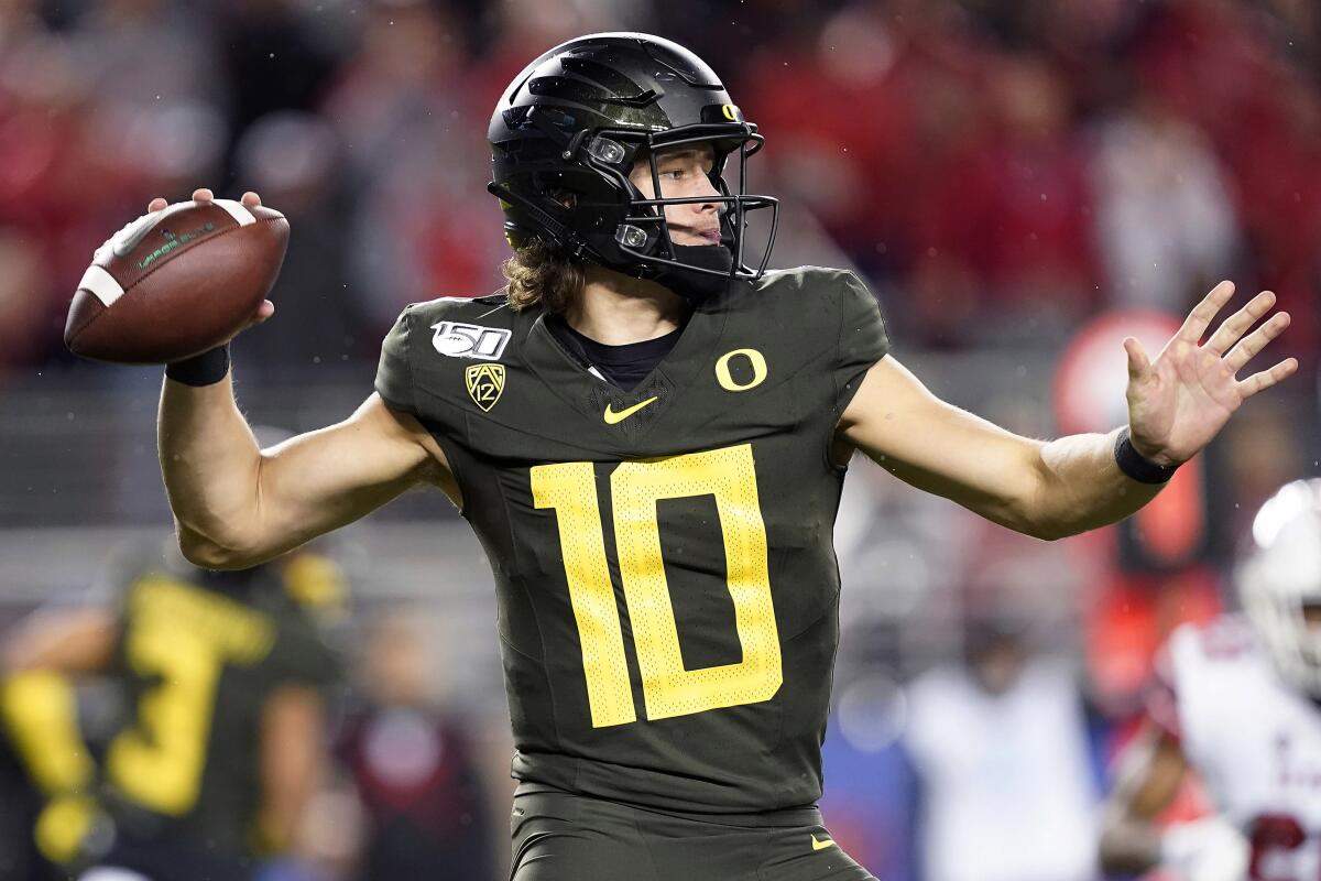 Oregon quarterback Justin Herbert throws a pass against Utah during the second half of the Pac-12 championship game in Santa Clara on Friday.