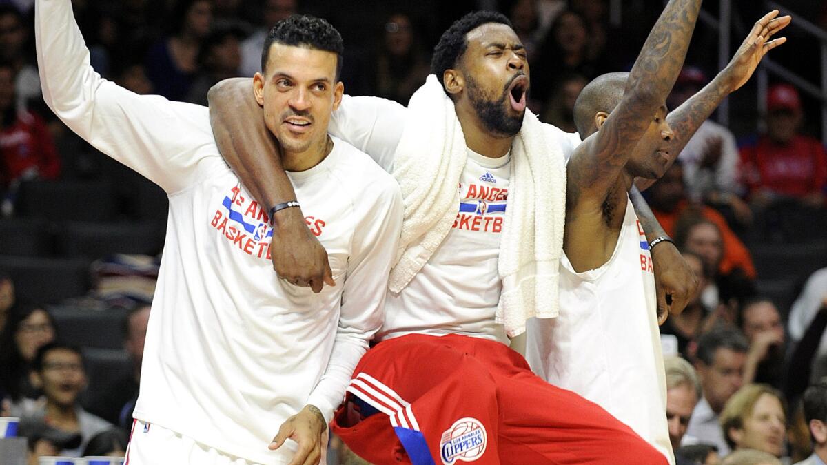 Clippers teammates (from left) Matt Barnes, DeAndre Jordan and Jamal Crawford celebrate from the bench during a 127-101 victory over the Minnesota Timberwolves at Staples Center on Monday.