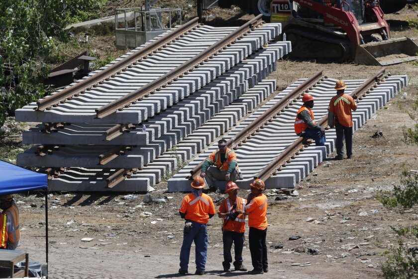 New rail lines are stacked near the site of a deadly train derailment in Philadelphia as work continues May 15 to resume service.