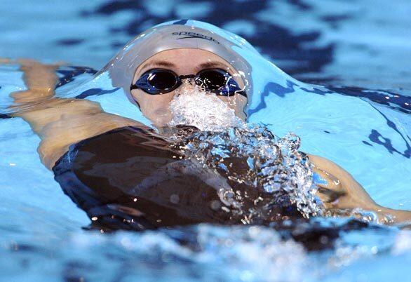 Natalie Coughlin swims to a world record time of 59.03 seconds in the women's 100-meter backstroke preliminaries at the U.S. Olympic swimming trials in Omaha, Neb.