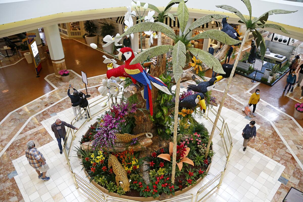 Visitors view a two-story display by Fiesta Parade Floats Friday during South Coast Plaza's "Home in the Garden." 