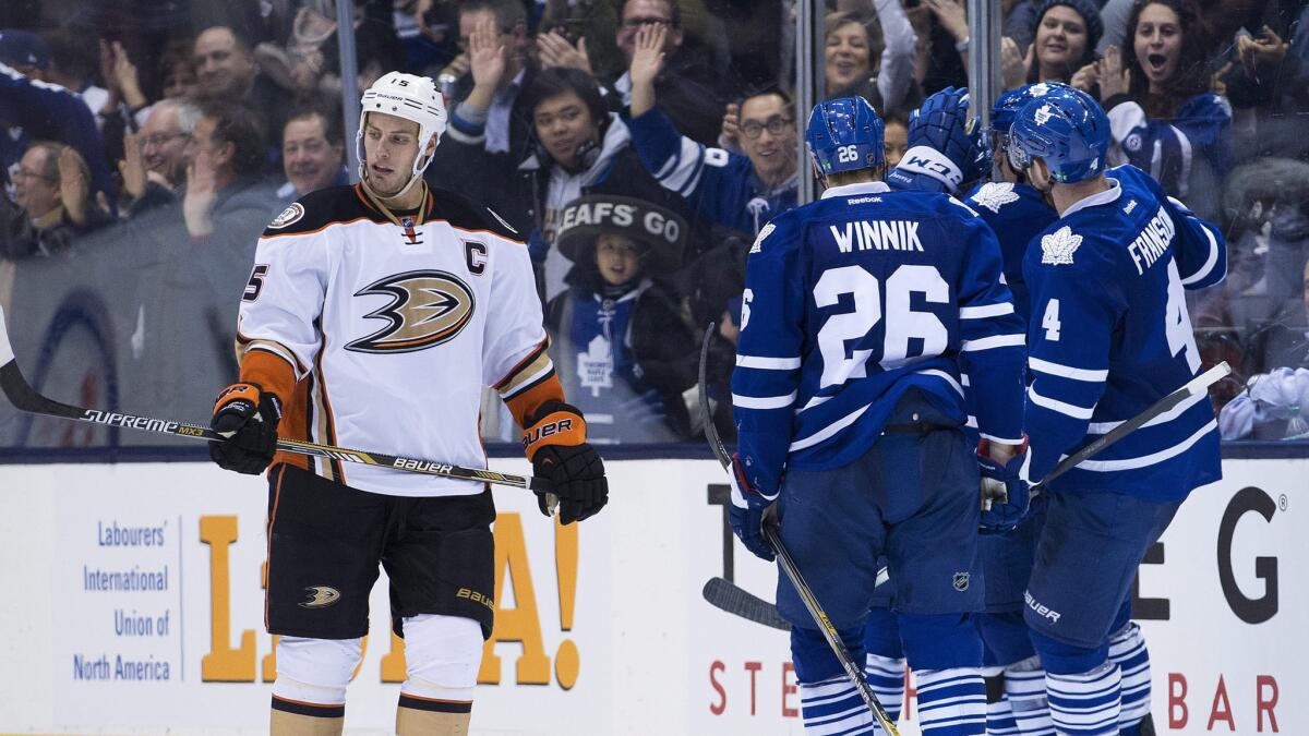 Ducks captain Ryan Getzlaf skates away as the Toronto Maple Leafs celebrate a third-period goal during the Ducks' 6-2 loss Tuesday.