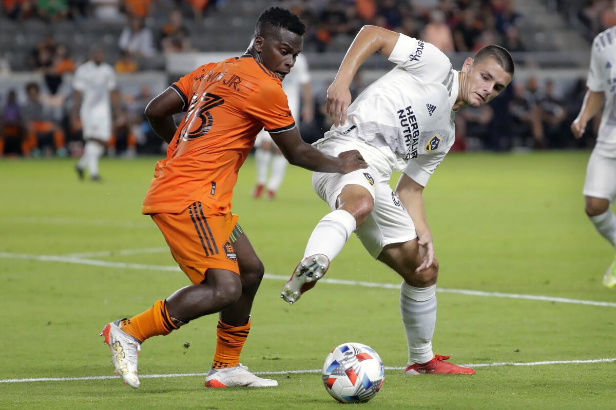 The Galaxy's Dejan Joveljic battles Houston Dynamo forward Carlos Darwin Quintero on Oct. 20, 2021.