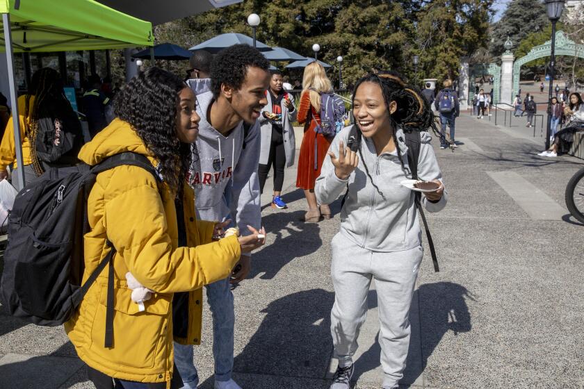 University of California Berkeley student Ahmad Mahmuod (center) chats with Kendall Dowell and Kyra Abrams (left-right) while hanging out during Black Wednesday on Sproul Plaza, Berkeley, CA, USA 19 Feb 2020. Black Wednesday is where black students can gather between classes to socialize and meet other black students in a dwindling black population at UC Berkeley. (Peter DaSilva for The Los Angeles Times)