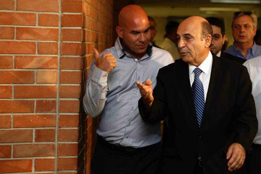 Shaul Mofaz, right, leader of the Kadima party, arrives for a special faction meeting at the Knesset on July 11, 2012, in Jerusalem.