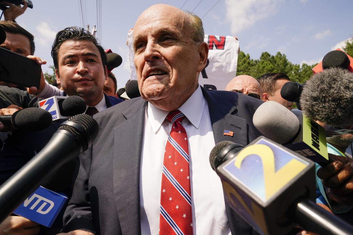 Rudolph W. Giuliani speaks to reporters.