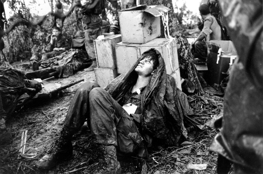 A wounded U.S. paratrooper grimacing in pain