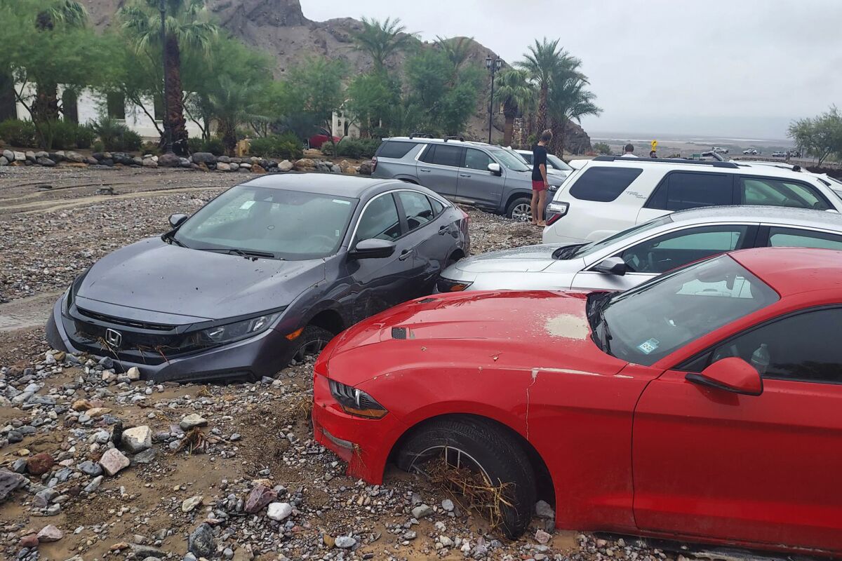 Cars are buried in mud and debris from a flash flood in Death Valley National Park.