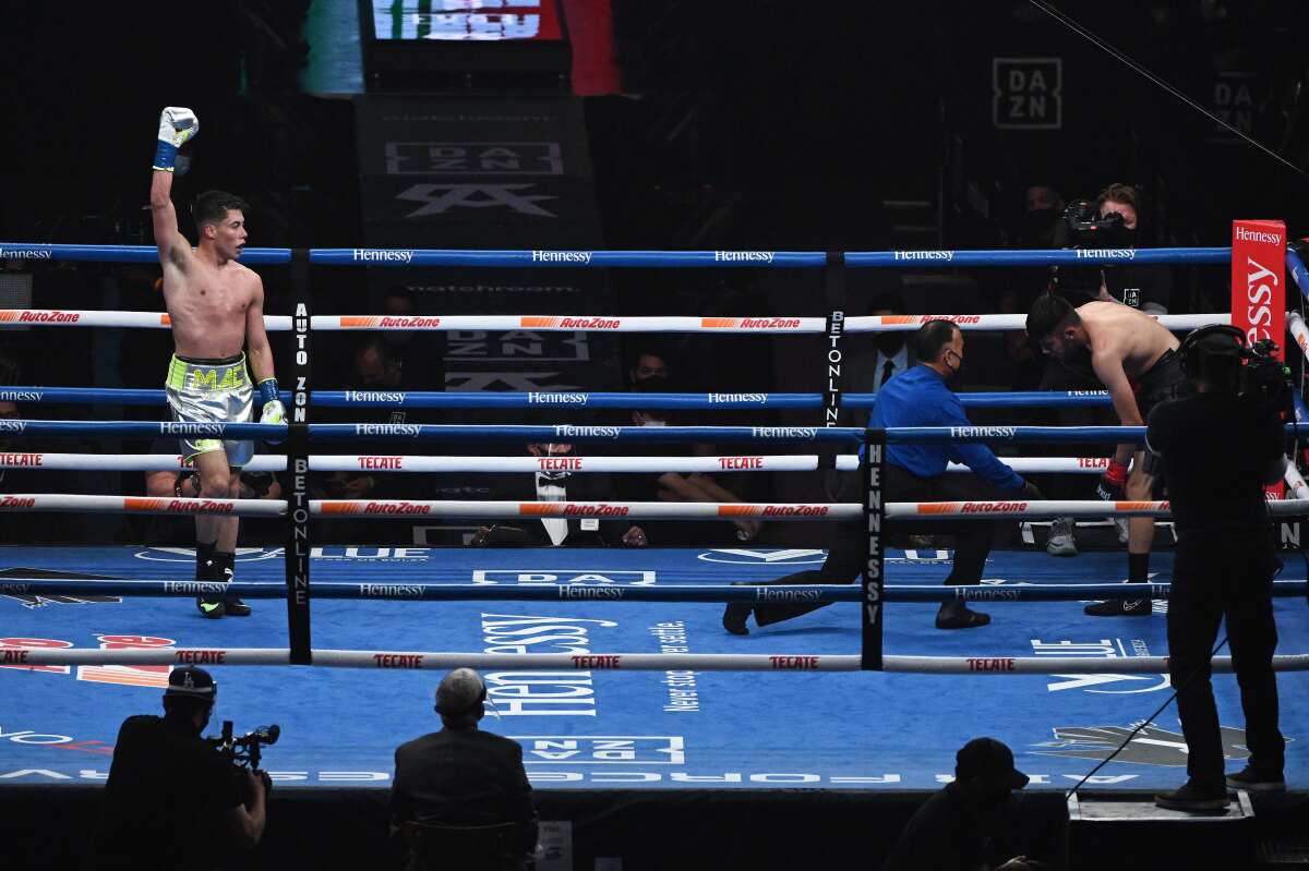 Marc Castro, left, celebrates after knocking down Luis Javier Valdes at the Alamodome in San Antonio on Saturday.