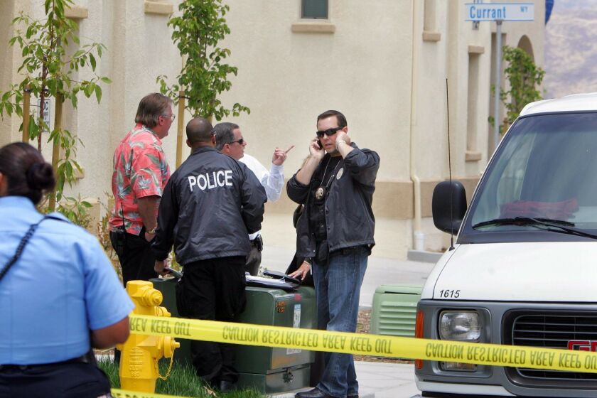 Investigators work at the scene of what police say may be a murder-suicide on Wednesday in Chula Vista.