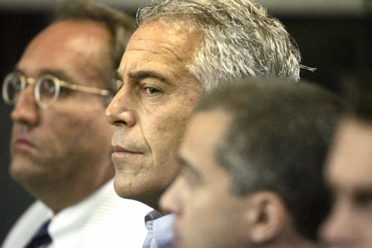 Jeffrey Epstein, center, appearing in court with his lawyers.