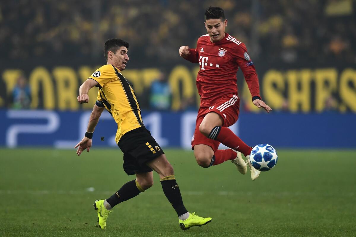 AEK's Greek midfielder Petros Mantalos (L) vies with Bayern Munich's Colombian midfielder James Rodriguez during the UEFA Champions League football match between AEK Athens FC and FC Bayern Munchen at the OACA Spyros Louis stadium in Athens on October 23, 2018.