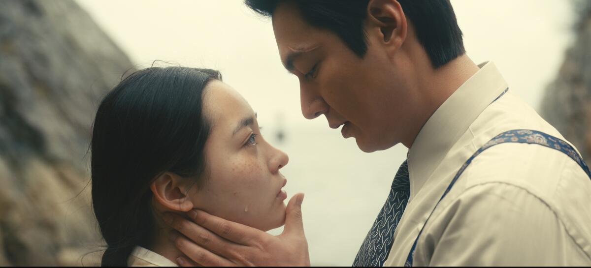A man holds a tearful woman's face