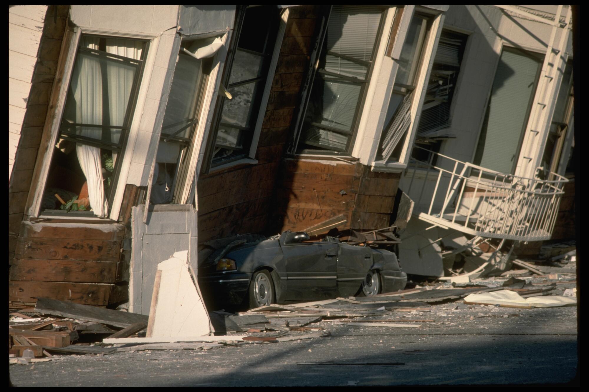 Third floor of apartment building collapsed on parked car
