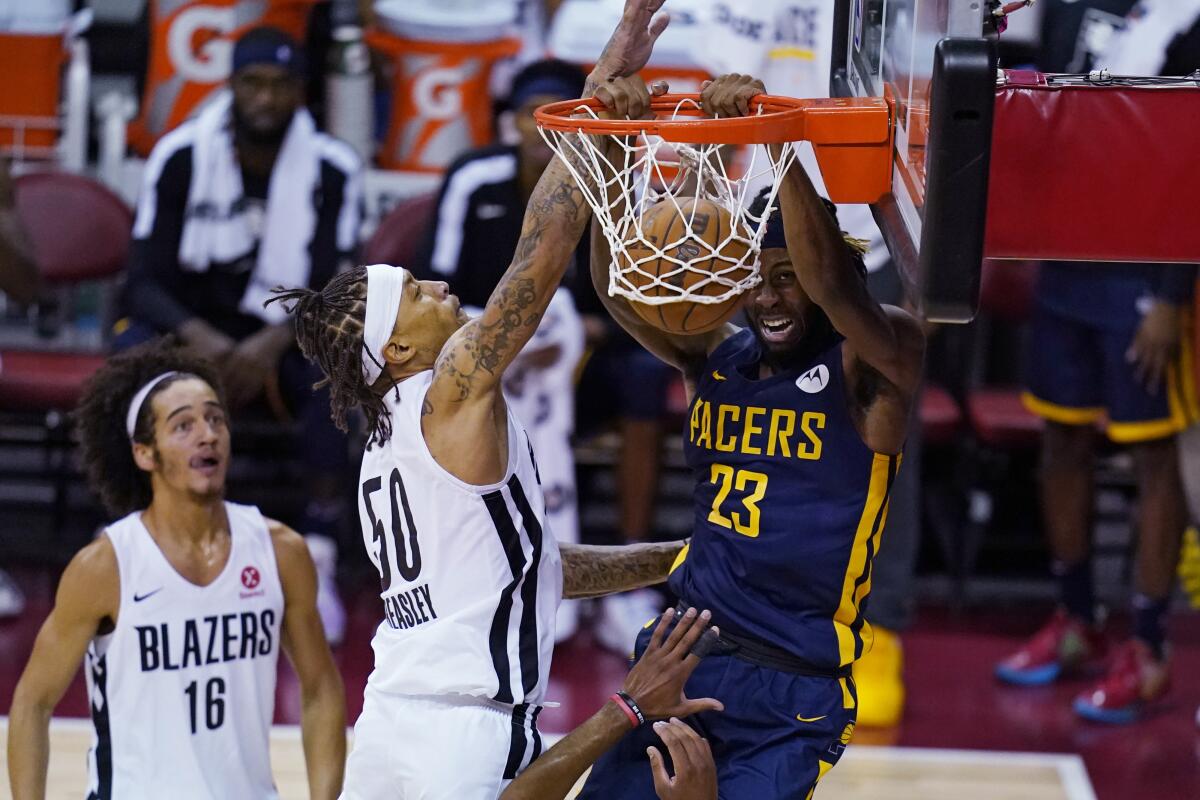 Indiana Pacers' Isaiah Jackson dunks against Portland Trail Blazers' Michael Beasley during the first half of an NBA summer league basketball game Thursday, Aug. 12, 2021, in Las Vegas. (AP Photo/John Locher)