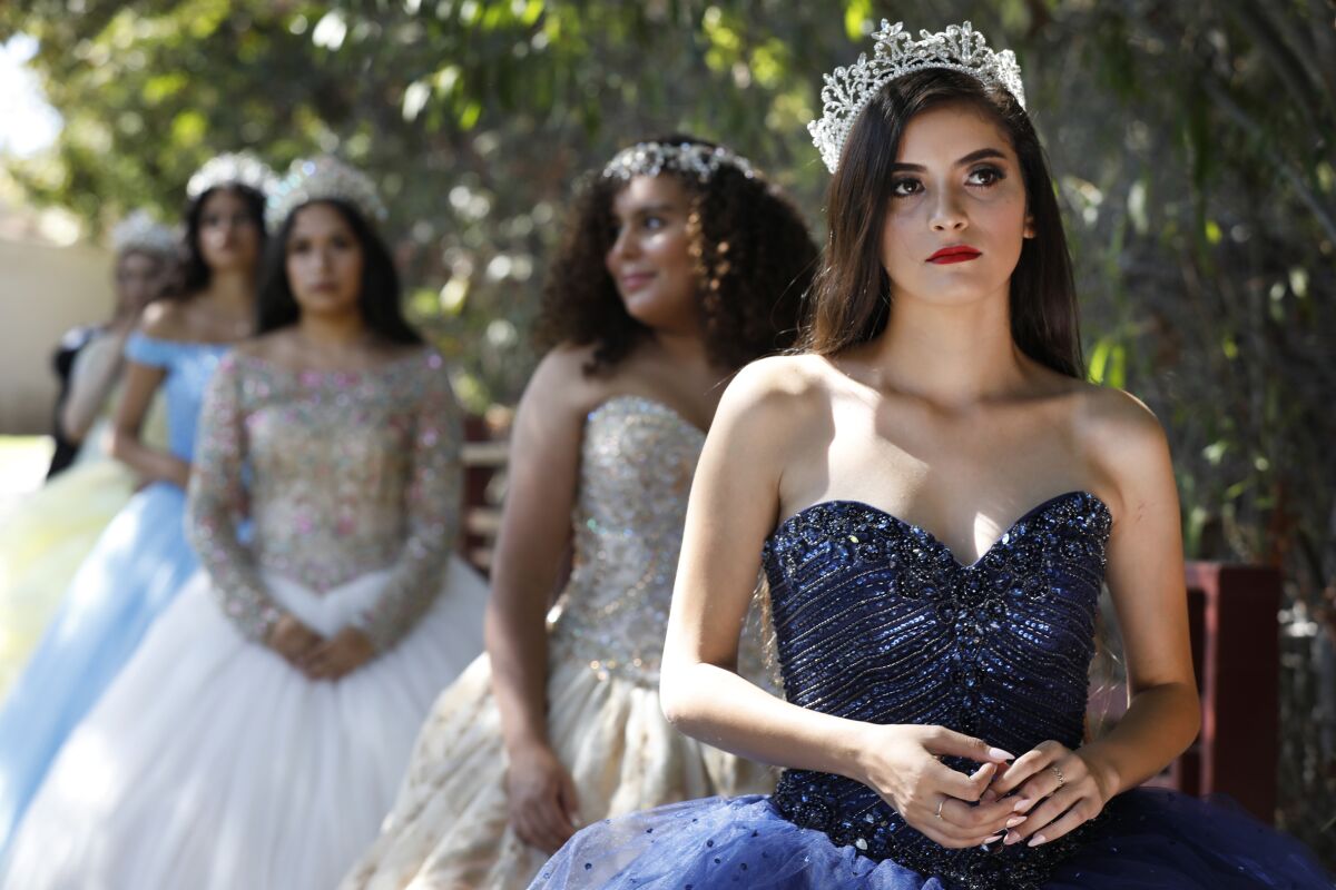 Valeria Amor, 19, leads a group of models as they take the stage for a fashion show featuring gowns from Lili's Creations in Chula Vista. The show was one of a number of cultural attractions showcased at the Hispanic Heritage Festival.