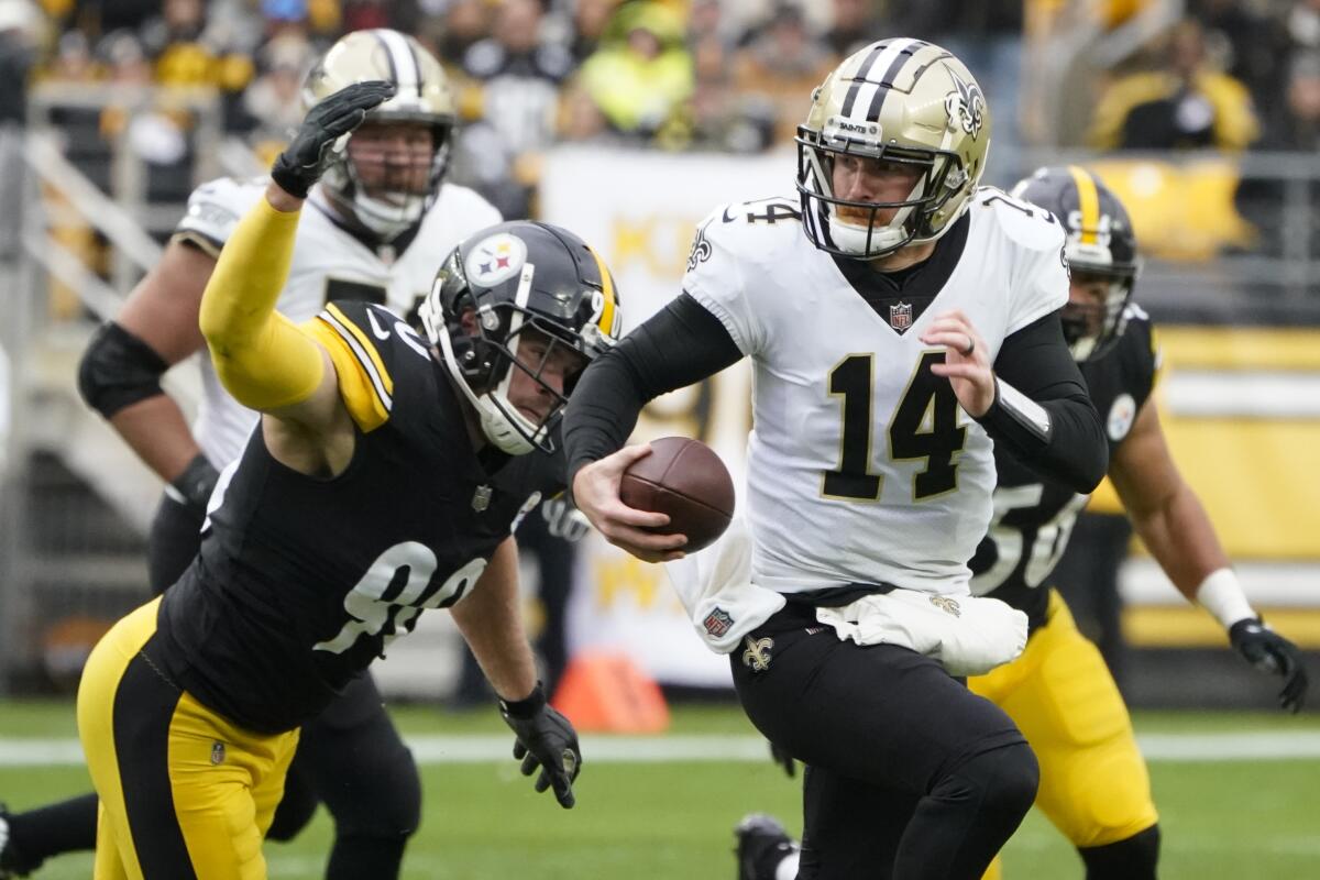Pittsburgh Steelers linebacker T.J. Watt, left, chases New Orleans Saints quarterback Andy Dalton.