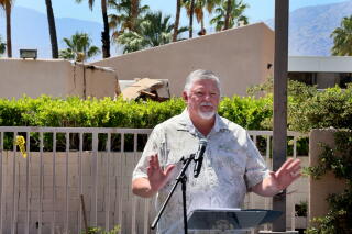 Palm Springs mayor Ron deHarte speaks during an outdoor news conference.