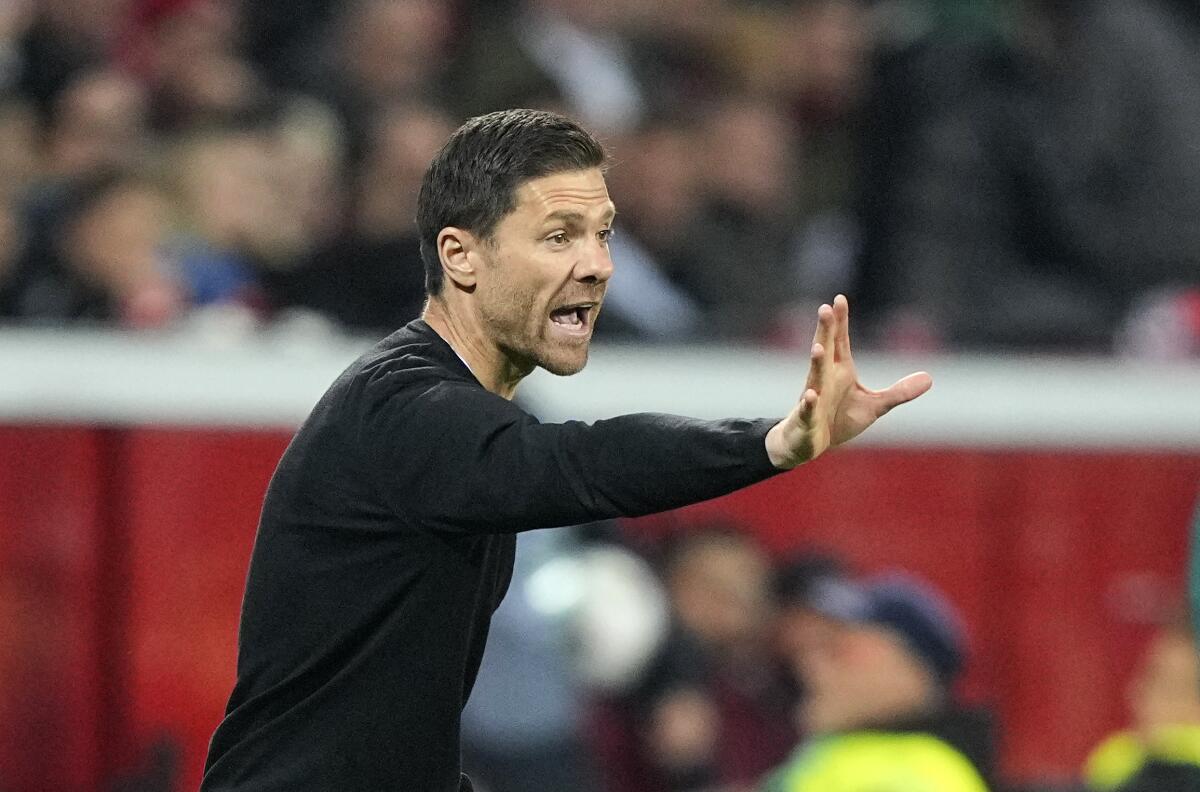 Leverkusen's head coach Xabi Alonso gives instructions to his players during the Champions League Group B soccer match between Bayer Leverkusen and Porto in Leverkusen, Germany, Wednesday, Oct. 12, 2022. (AP Photo/Martin Meissner)