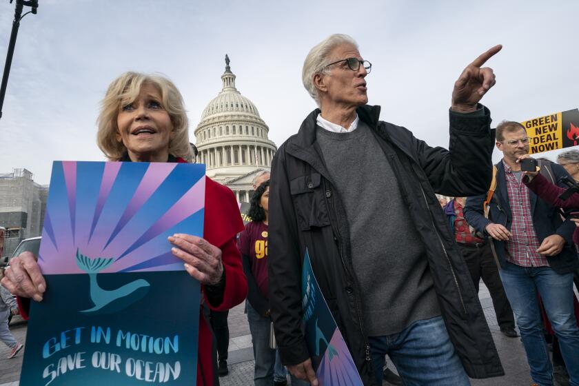 Actress and activist Jane Fonda, left, is joined by actor Ted Danson, right, as they and other demonstrators call on Congress for action to address climate change, in Washington, Friday, Oct. 25, 2019. (AP Photo/J. Scott Applewhite)