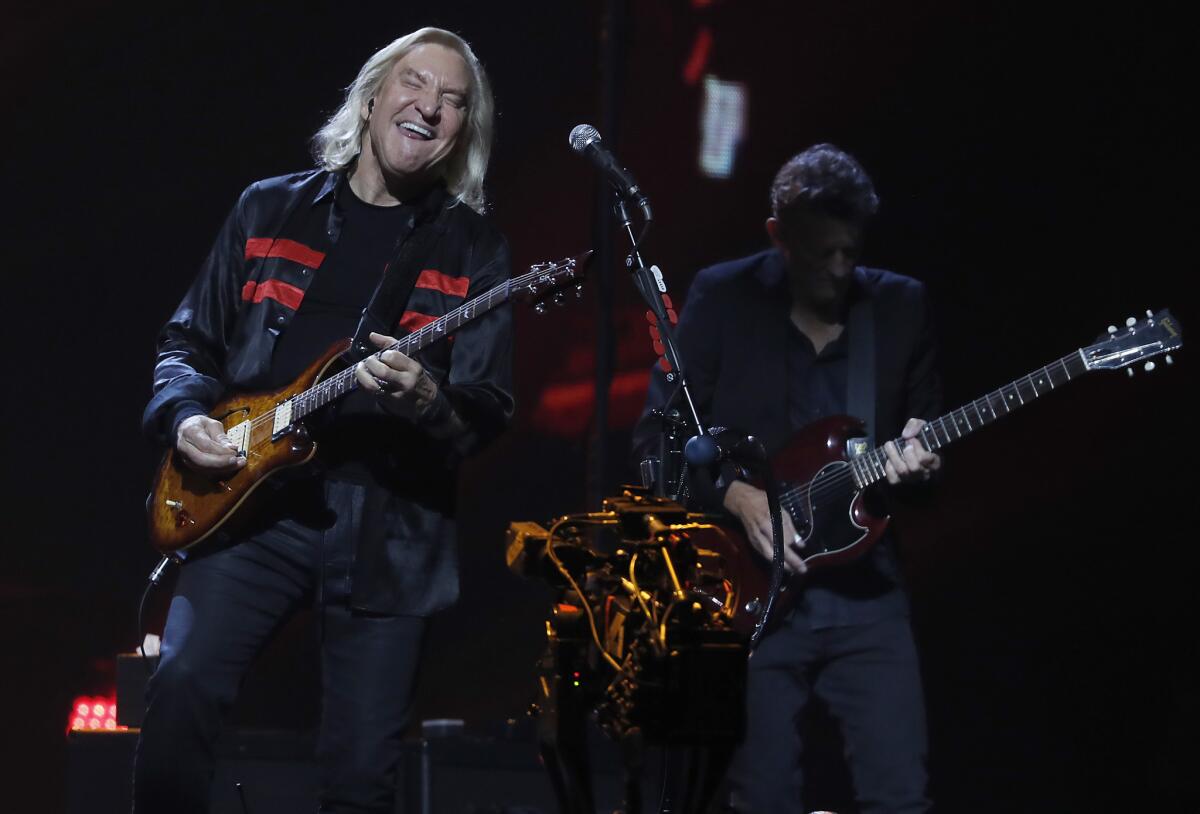 Joe Walsh, left, performs with the Eagles on Wednesday night at the Forum in Inglewood.