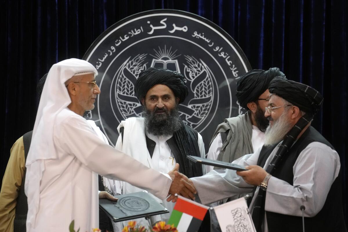 Mullah Abdul Ghani Baradar, center, Taliban-appointed Deputy Prime Minister, attends a document signing ceremony with the Abu Dhabi-based firm GAAC Solutions, in Kabul, Afghanistan, Thursday, Sept. 8, 2022. The Taliban signed a contract Thursday with GAAC Solutions that will provide flight guidance services which will include equipping the air service and staff training for the air services in three major airports including the capital Kabul. (AP Photo/Ebrahim Noroozi)